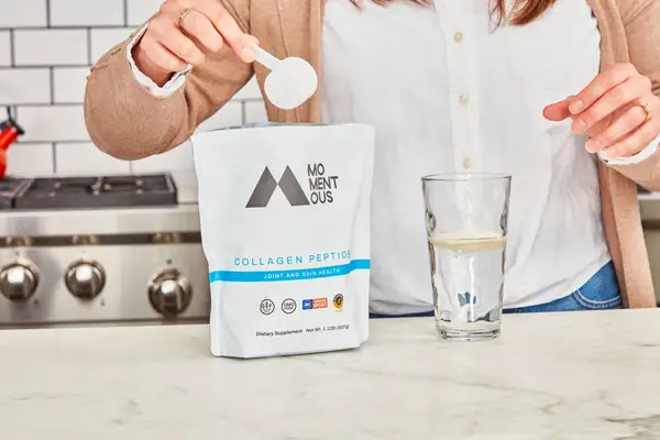 Momentous Collagen Peptides is poured inside water