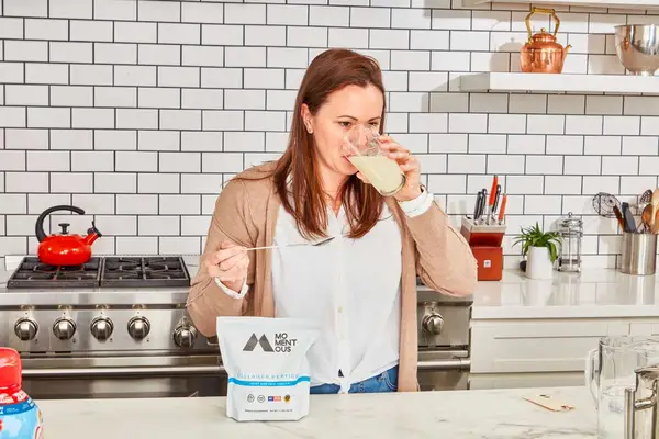 Person drinking Momentous Collagen Peptides