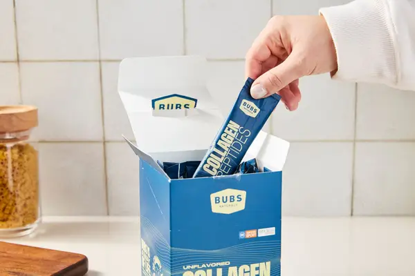Person taking out packet of Bubs Naturals Collagen Peptides