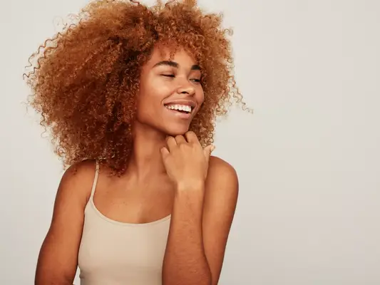 A woman smiling with bright white teeth