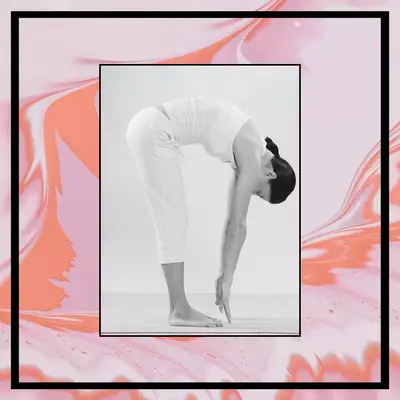 woman touching toes in standing forward bend to relieve bloating