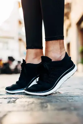 closeup of person stretching feet outside