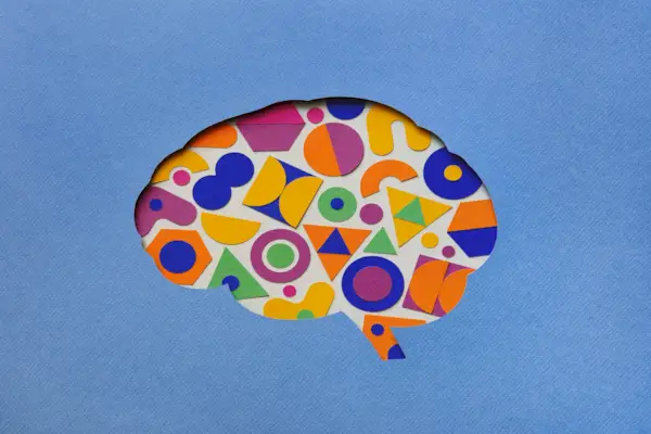 Paper brain silhouette with geometric shapes