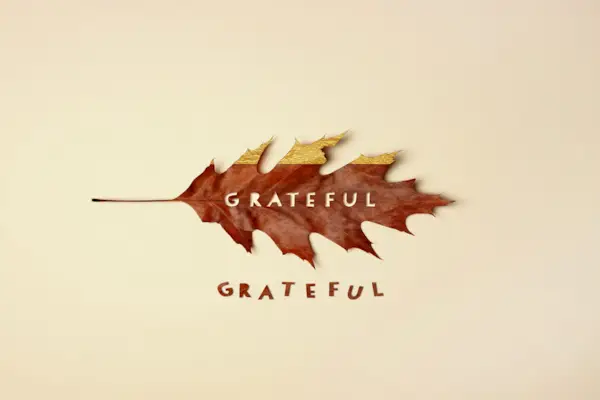 Fall leaf with text cutout reading grateful