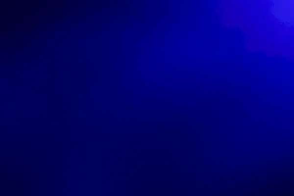 abstraktní měkké a rozmazané tmavě modré pozadí