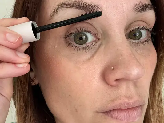 A person using the Anastasia Beverly Hills Brow Freeze Extreme Hold Laminated-Look Sculpting Wax