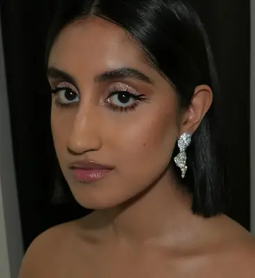 Ambika Mod wears a glittery eyeshadow look with prominent false eyelashes