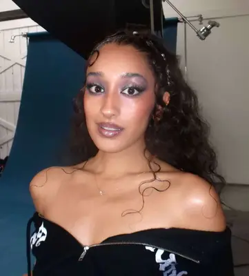 Raveena Aurora wears a smoky grey and lilac eyeshadow look that shimmers