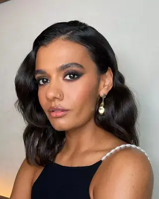 Madeleine Madden in soft smokey eye makeup with wavy retro hair