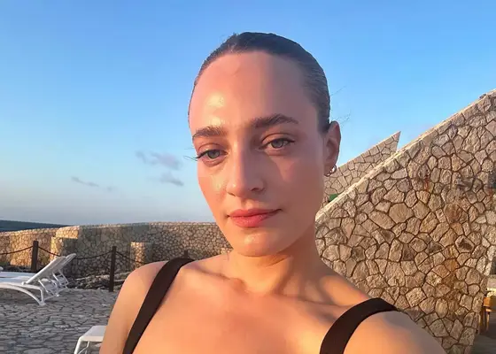 close up of hallie gould wearing makeup during golden hour