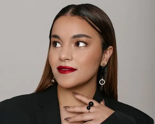 A woman in bright red lipstick, her head turned slightly to her right