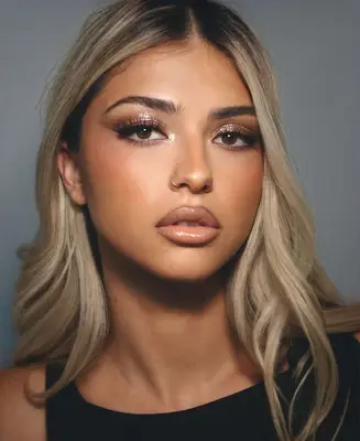 model wears nude glossy makeup look