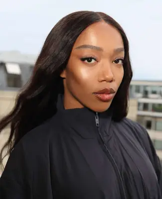 model poses wearing natural nude makeup look with berry lip gloss