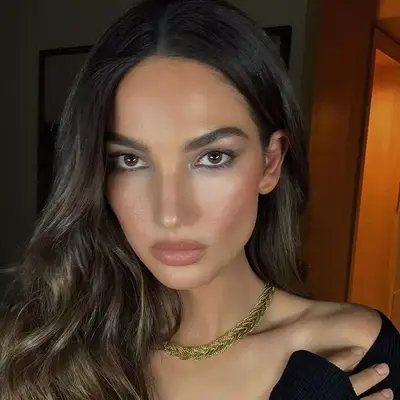 Lily Aldridge with sheer eyeshadow, nude lips, and wavy hair