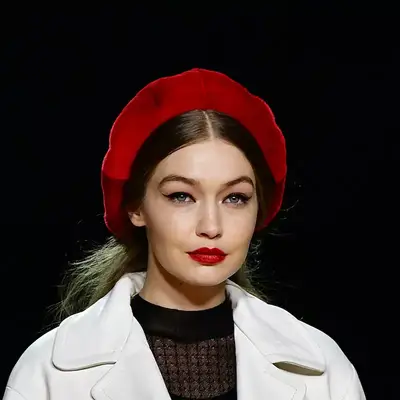 Gigi Hadid with a cream coat, a red beret, and red lips at the Marc Jacobs Fall 2020 runway show in New York City