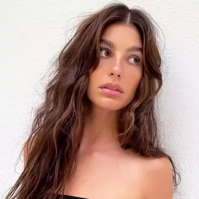 Camila Morrone with wavy hair and bold eyebrows