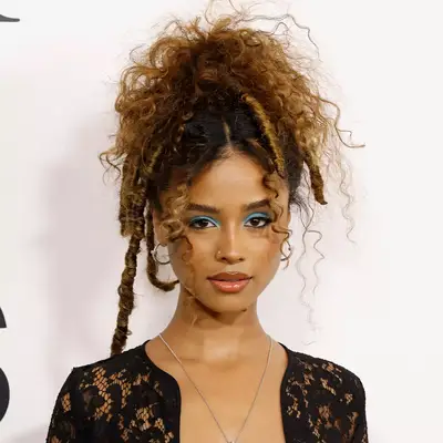 Tyla with vibrant blue eyeshadow and a black dress at the 2024 CFDA Fashion Awards in New York City