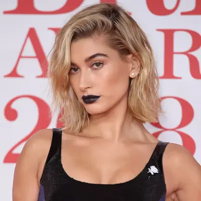 Hailey Bieber with black lipstick and a black dress at the 2018 BRIT Awards in London, England