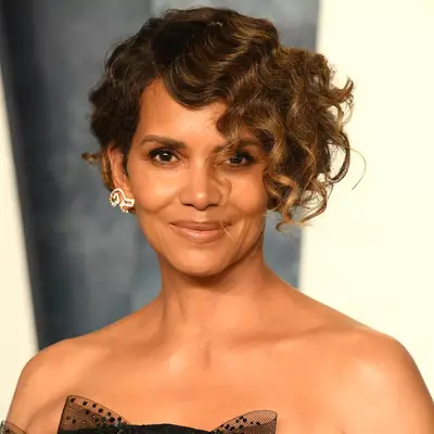 Halle Berry with a curly bob and shimmering skin at the 2023 Vanity Fair Oscar Party in Beverly Hills, California
