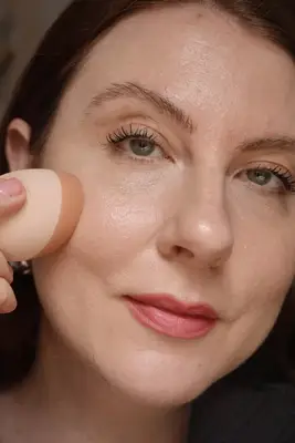 alix earle earing liquid foundation and hair in updo