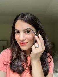 A person holding the L