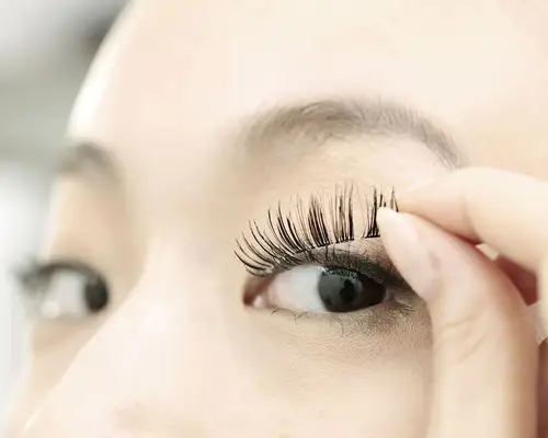 closeup of false eyelash application
