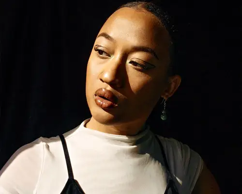 stylish young woman with neutral tone makeup