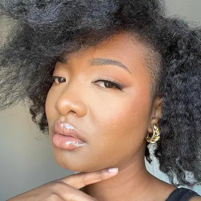 Woman with flawless complexion and lip gloss