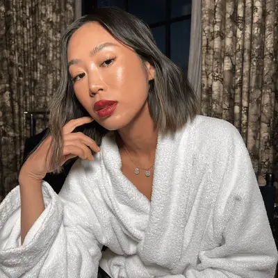 model wearing red lipstick and highlighted skin