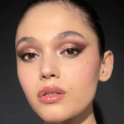 model wearing ethereal shimmery eyeshadow and lip gloss