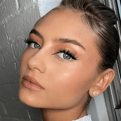 woman wearing graphic black eyeliner and neutral makeup