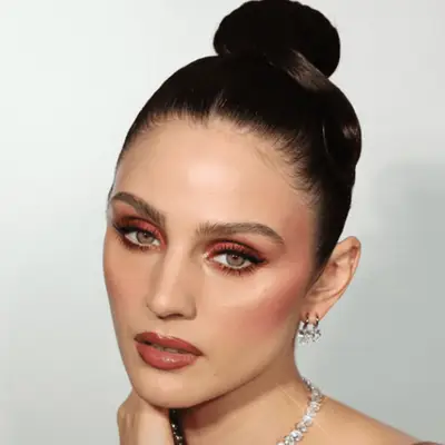 model wearing rosy eyeshadow, blush, and lipstick