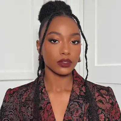 model wearing peach eyeshadow and berry lipstick