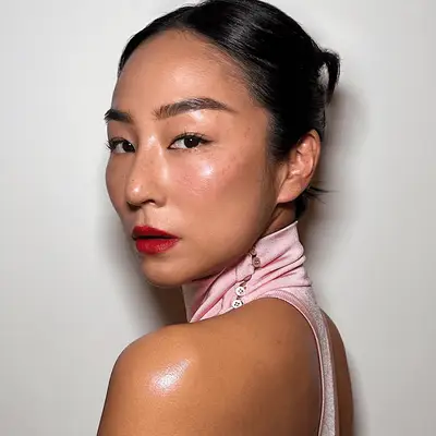 greta lee wearing red lip and radiant makeup