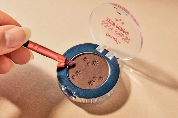 A person applies Benefit Goof Proof Brow Powder