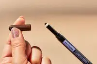 A person places a cap on the Maybelline Express Brow Duo 2-in-1 Pencil and Powder