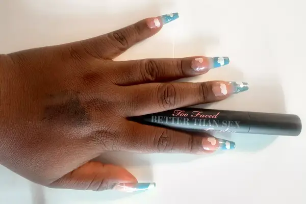 Too Faced Better Than Sex Foreplay Mascara Primer applied to the back of a person