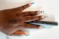 Too Faced Better Than Sex Foreplay Mascara Primer applied to the back of a person