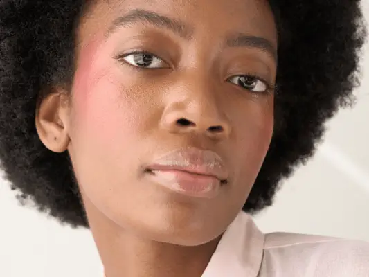 A woman with blush draped on her cheeks