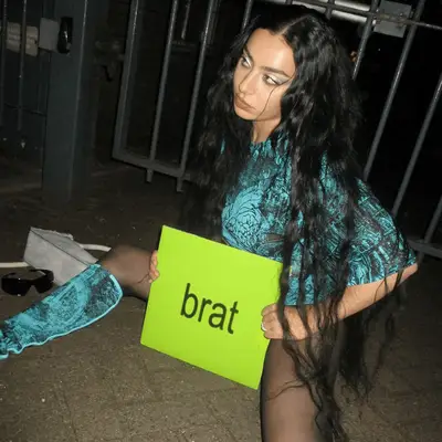 charli xcx holding brat album