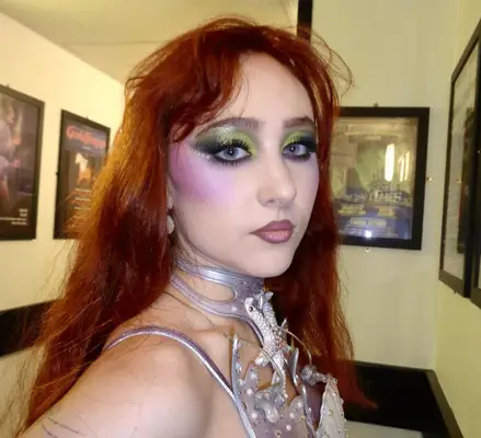 Chappell Roan wearing a green and pink makeup look.