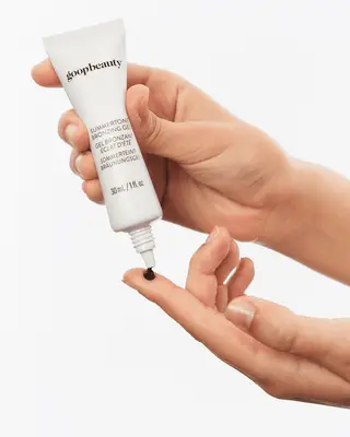 model swatching the goop bronzing gel