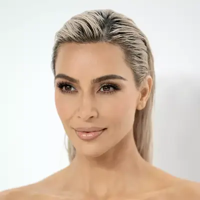 Kim Kardashian with blonde hair and tapered eyebrows attends the CFDA Fashion Awards