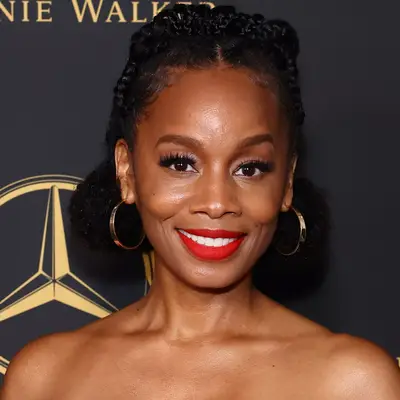 Anika Noni Rose with short eyebrows, half-up hairstyle and red lipstick attends 2023 WIF (Women In Film) Oscar Party
