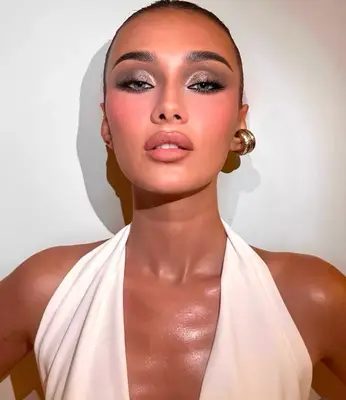 model wears silver sparkly eyeshadow and pink blush