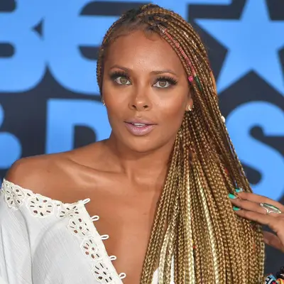 Eva Marcille with taupe eyeshadow, lashes, glossy lips, and subtle neutral makeup