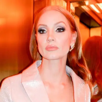 Jessica Chastain with gray and white shimmer eyeshadow, heavy eyeliner, lashes, green eyes, and subtle neutral lipstick