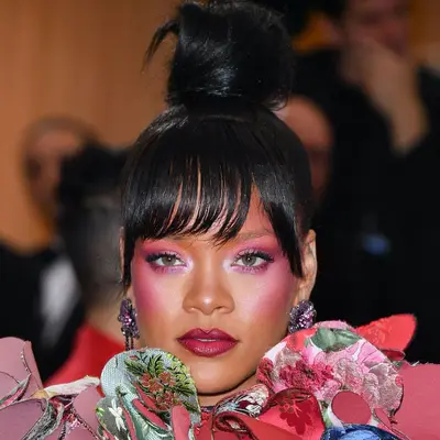 Rihanna wears hot pink eyeshadow and blush with berry-toned lipstick