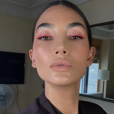 Lily Aldridge in a sparkly pink eyeshadow look with neon pink liner.