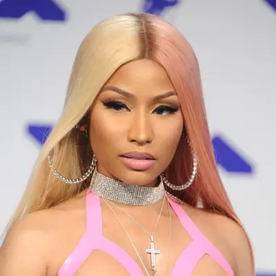 Nicki Minaj wearing neutral eyeshadow and pink lip gloss with two tone pink and blonde hair.
